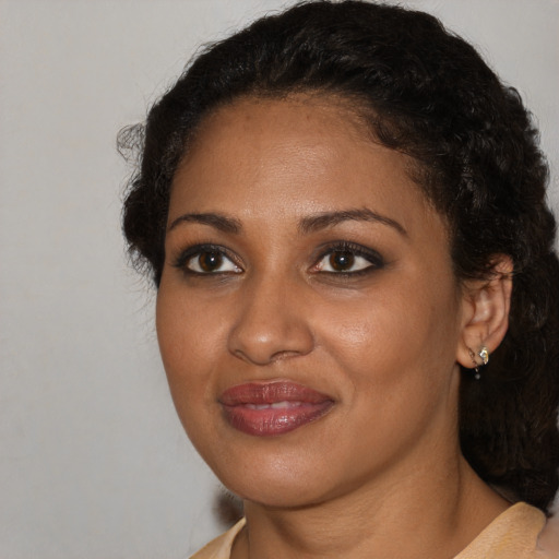 Joyful black young-adult female with medium  brown hair and brown eyes