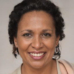 Joyful black adult female with medium  brown hair and brown eyes