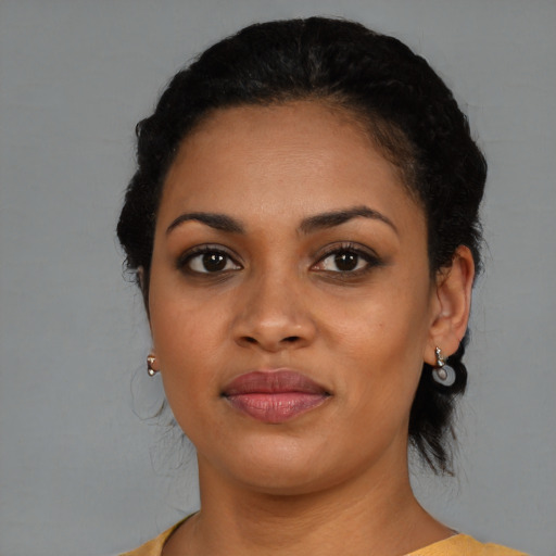 Joyful black young-adult female with medium  black hair and brown eyes