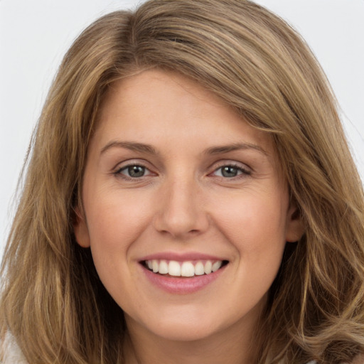 Joyful white young-adult female with long  brown hair and green eyes