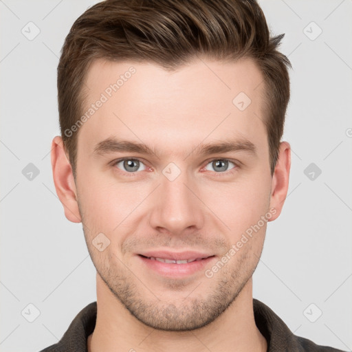 Joyful white young-adult male with short  brown hair and grey eyes