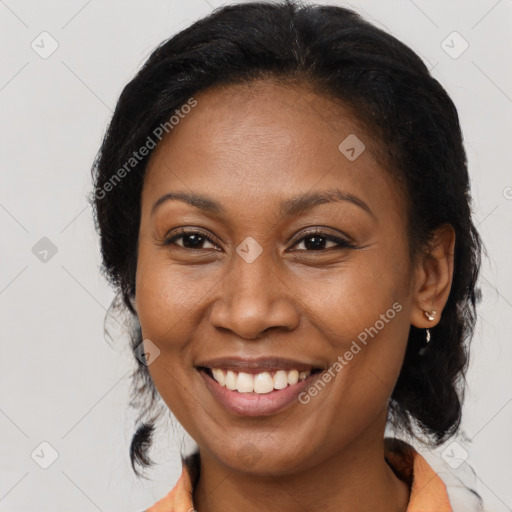 Joyful black adult female with medium  brown hair and brown eyes