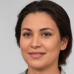 Joyful white adult female with medium  brown hair and brown eyes