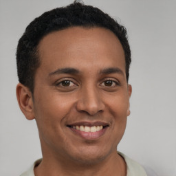 Joyful latino young-adult male with short  brown hair and brown eyes