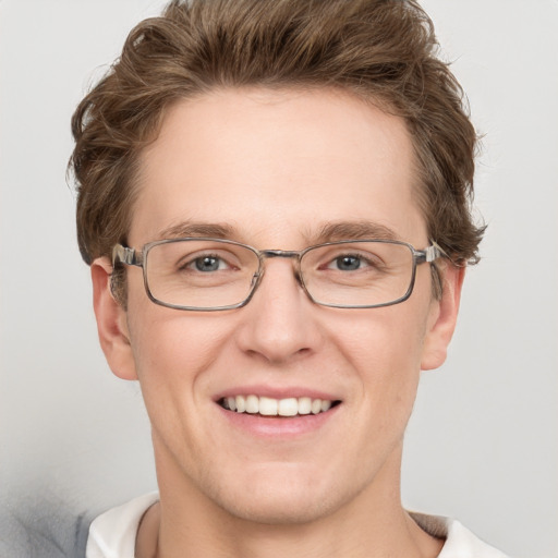 Joyful white adult male with short  brown hair and grey eyes