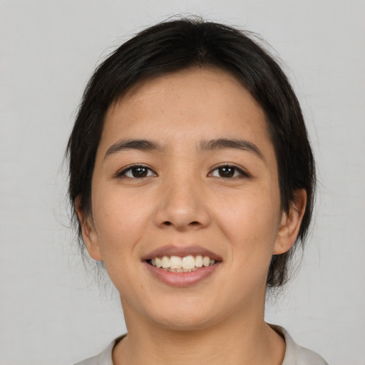 Joyful asian young-adult female with medium  brown hair and brown eyes