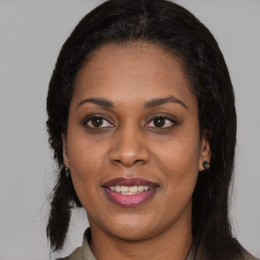 Joyful latino adult female with medium  black hair and brown eyes