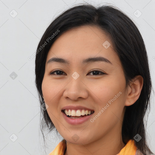 Joyful asian young-adult female with medium  black hair and brown eyes