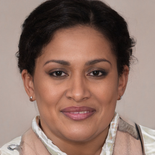 Joyful latino adult female with short  brown hair and brown eyes