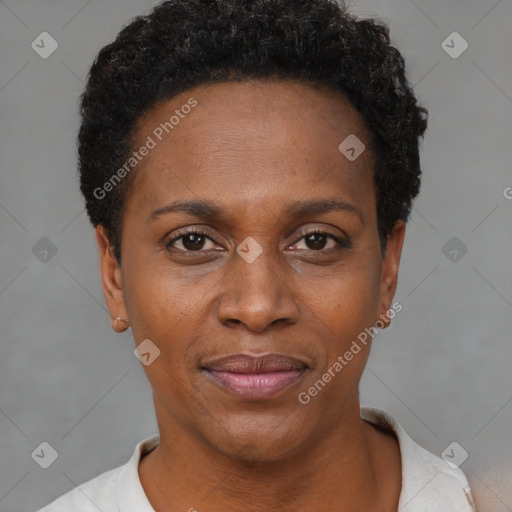 Joyful black young-adult female with short  black hair and brown eyes