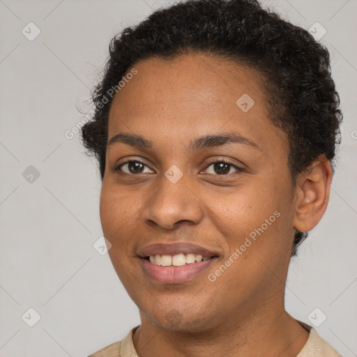 Joyful black young-adult female with short  brown hair and brown eyes