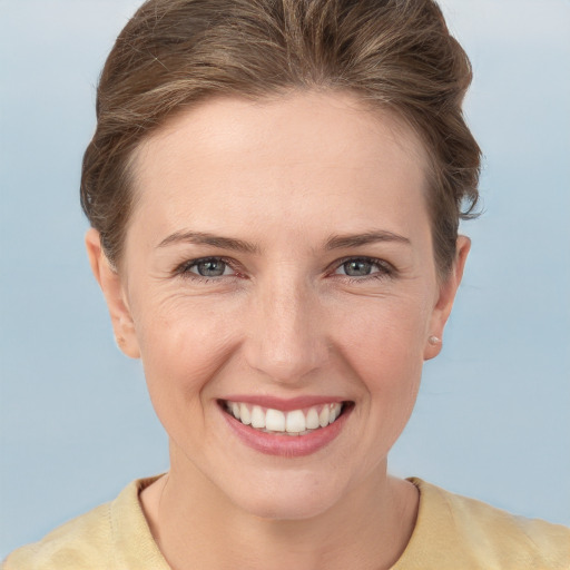 Joyful white young-adult female with short  brown hair and grey eyes