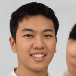 Joyful asian young-adult male with short  brown hair and brown eyes