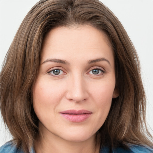 Joyful white young-adult female with medium  brown hair and blue eyes