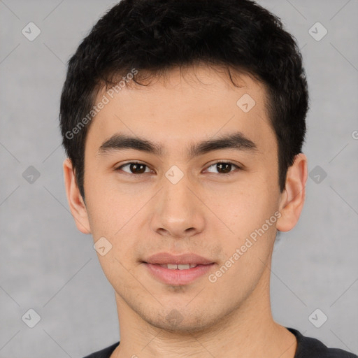 Joyful latino young-adult male with short  brown hair and brown eyes