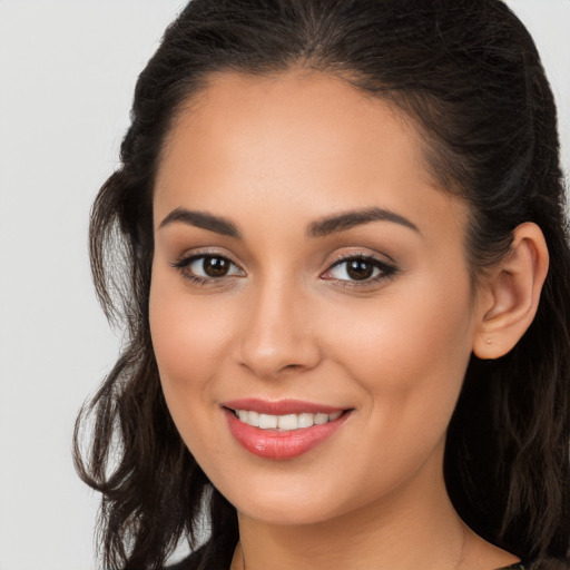 Joyful white young-adult female with long  brown hair and brown eyes