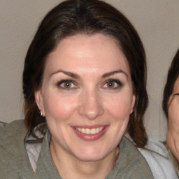 Joyful white adult female with medium  brown hair and brown eyes