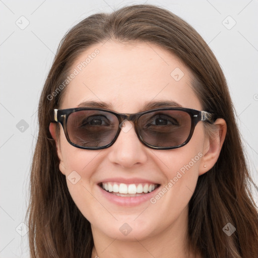 Joyful white young-adult female with long  brown hair and blue eyes