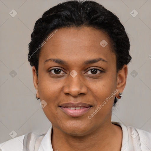 Joyful black young-adult female with short  black hair and brown eyes