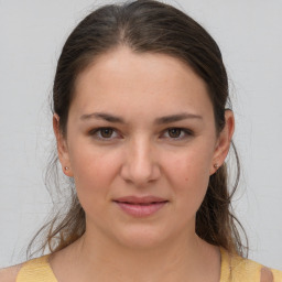 Joyful white young-adult female with medium  brown hair and brown eyes