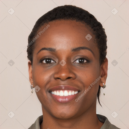 Joyful black young-adult female with short  brown hair and brown eyes