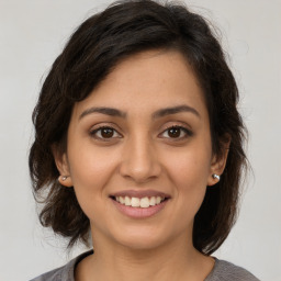 Joyful white young-adult female with medium  brown hair and brown eyes