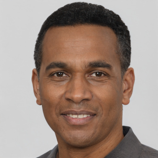 Joyful latino adult male with short  black hair and brown eyes