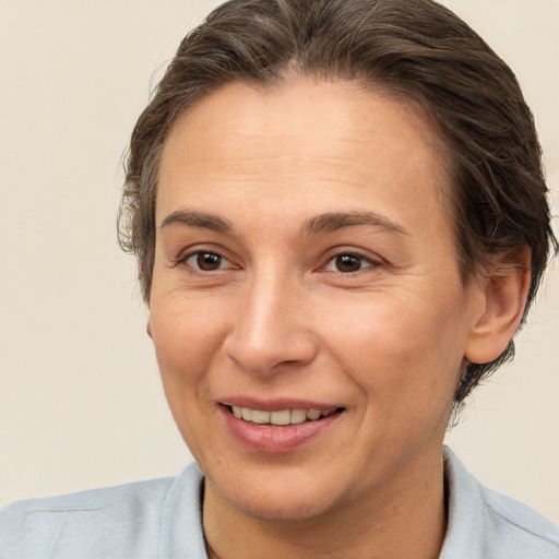 Joyful white adult female with short  brown hair and brown eyes