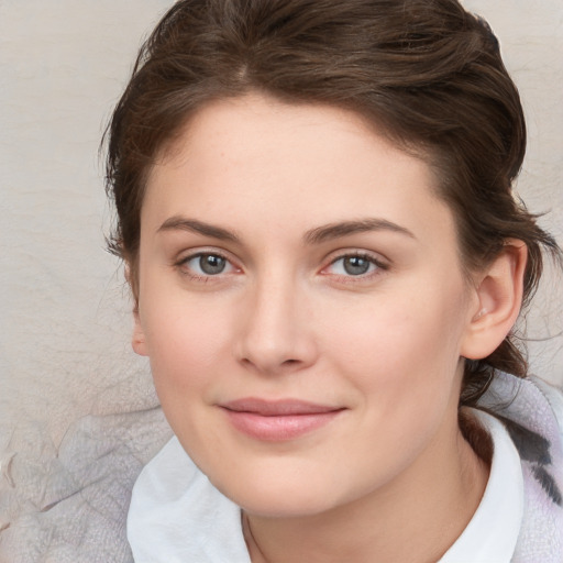 Joyful white young-adult female with medium  brown hair and blue eyes