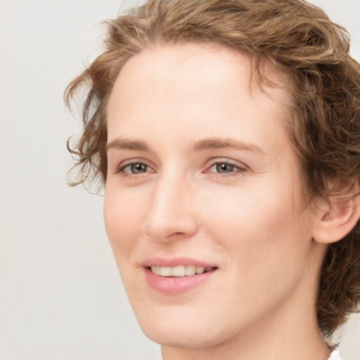 Joyful white young-adult female with medium  brown hair and green eyes