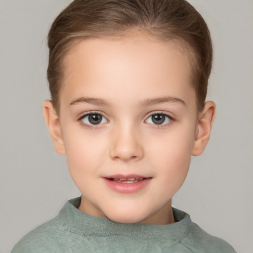 Joyful white child female with short  brown hair and brown eyes