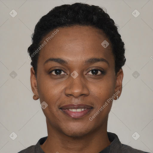 Joyful black young-adult female with short  black hair and brown eyes