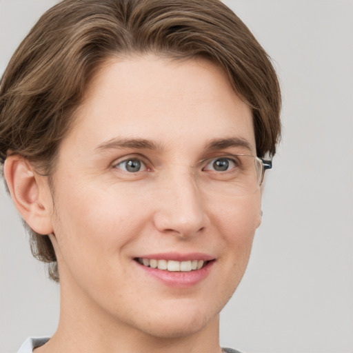 Joyful white young-adult female with short  brown hair and grey eyes