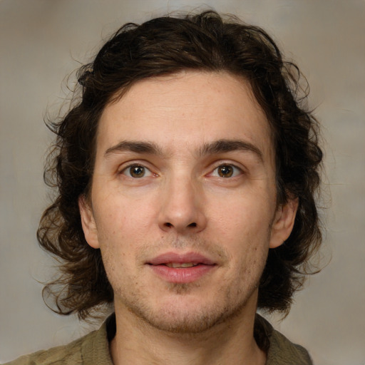 Joyful white young-adult male with medium  brown hair and brown eyes