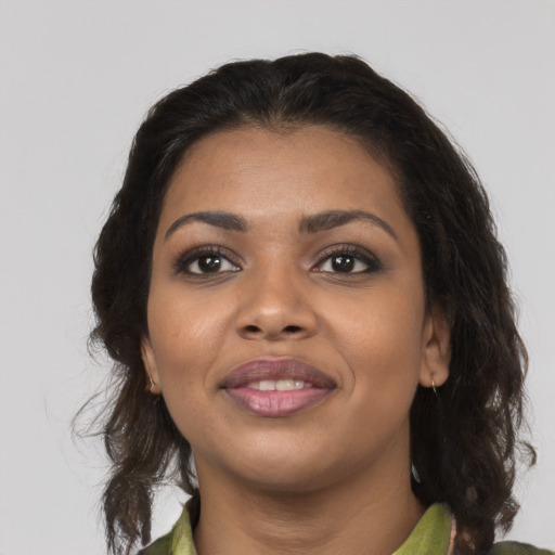 Joyful black young-adult female with medium  brown hair and brown eyes