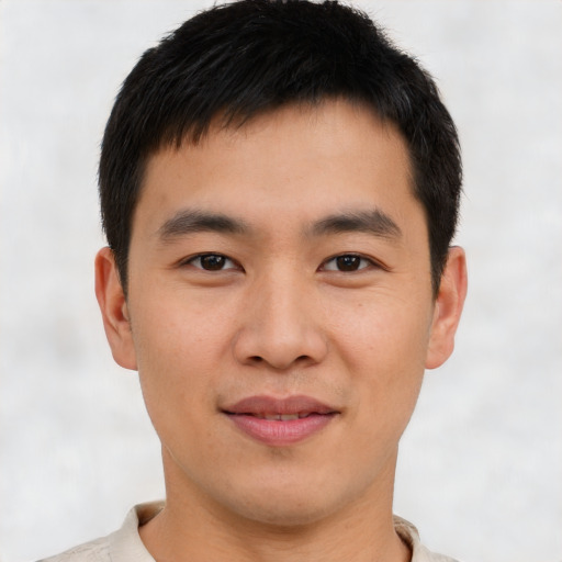 Joyful asian young-adult male with short  brown hair and brown eyes