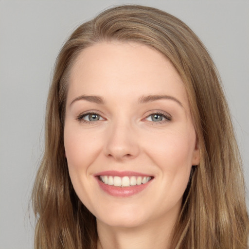 Joyful white young-adult female with long  brown hair and brown eyes