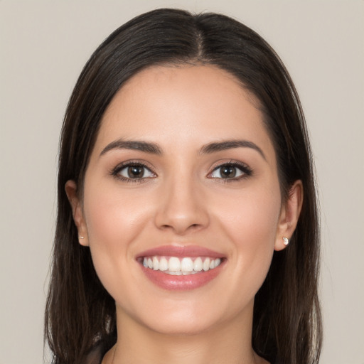 Joyful white young-adult female with long  brown hair and brown eyes