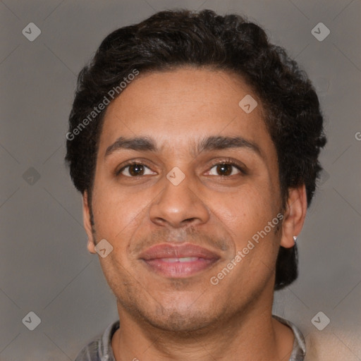 Joyful latino adult male with short  brown hair and brown eyes