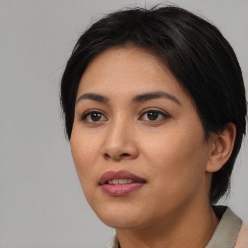Joyful asian young-adult female with short  black hair and brown eyes
