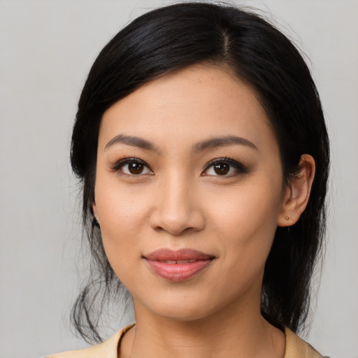 Joyful latino young-adult female with medium  black hair and brown eyes