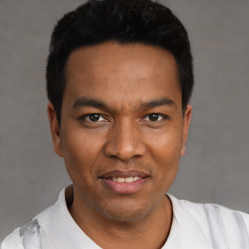 Joyful latino young-adult male with short  black hair and brown eyes
