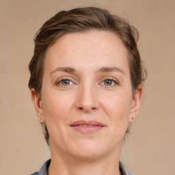 Joyful white adult female with medium  brown hair and grey eyes