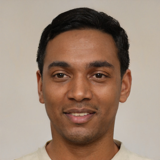 Joyful black young-adult male with short  black hair and brown eyes