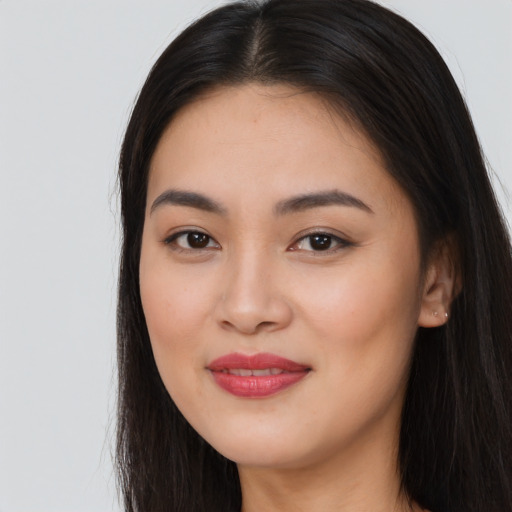 Joyful asian young-adult female with long  brown hair and brown eyes