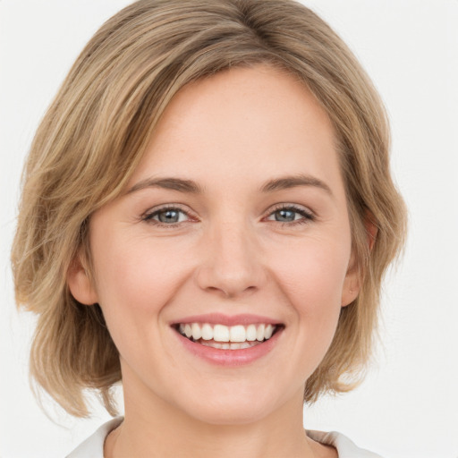 Joyful white young-adult female with medium  brown hair and green eyes