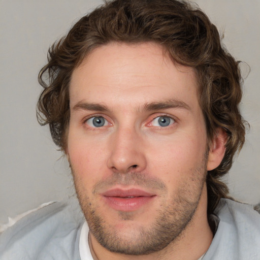 Joyful white young-adult male with short  brown hair and blue eyes