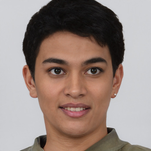 Joyful latino young-adult male with short  brown hair and brown eyes