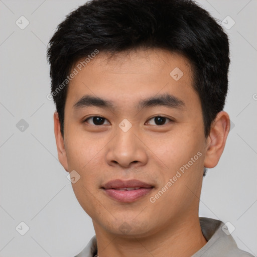 Joyful asian young-adult male with short  black hair and brown eyes