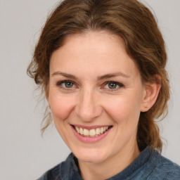 Joyful white adult female with medium  brown hair and grey eyes